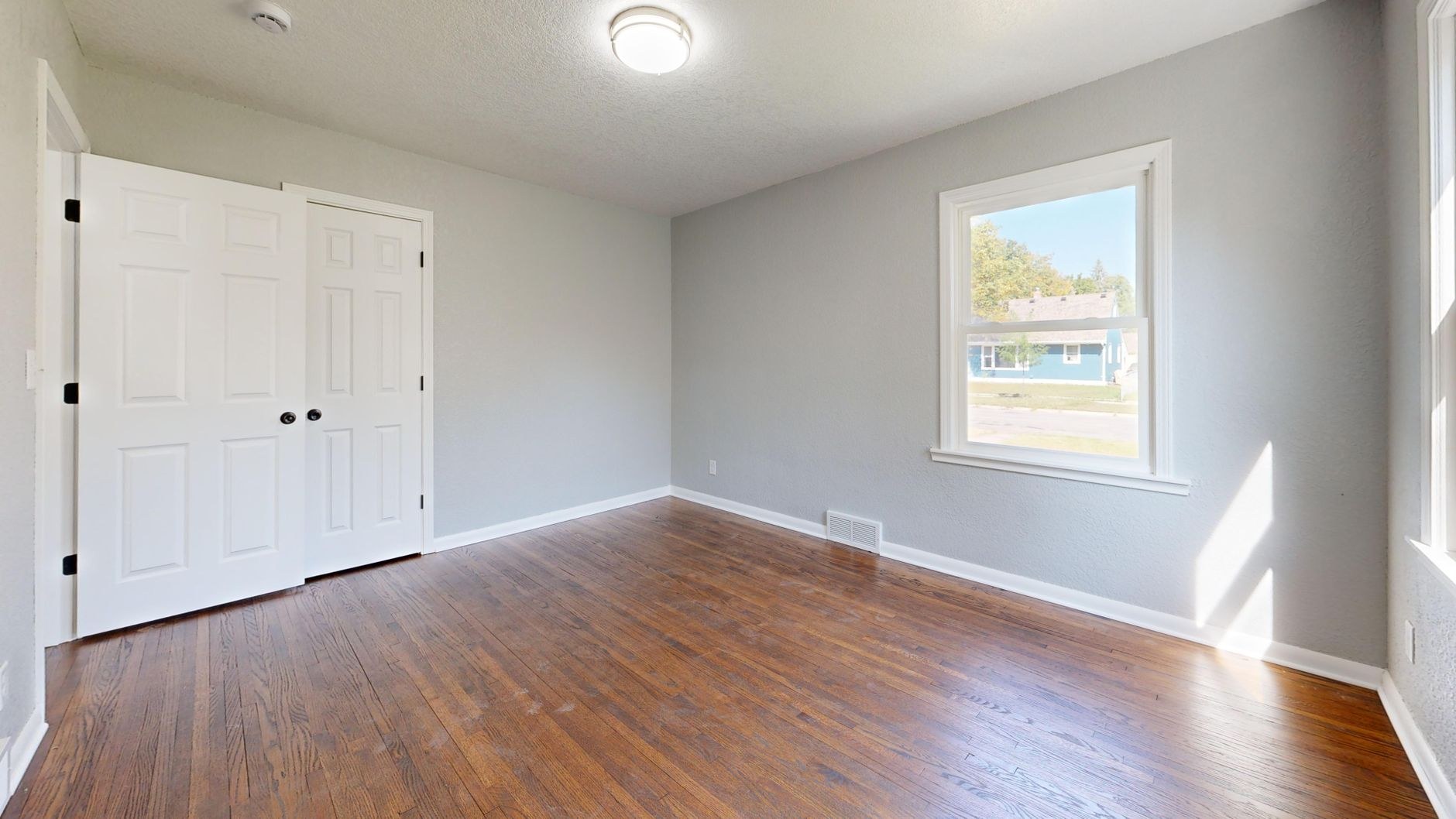 Freshly painted room with grey walls and window light